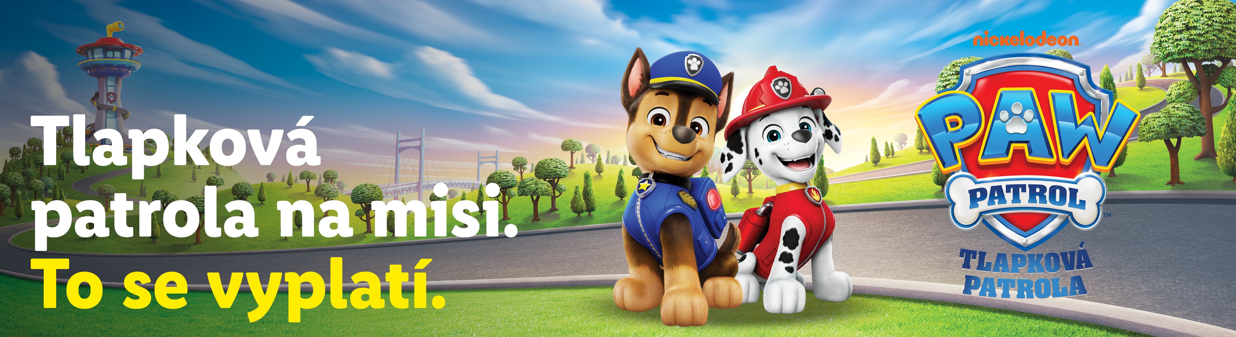 Širokoúhlý reklamní banner s tématikou Tlapkové patroly (PAW Patrol). V popředí stojí dvě kreslené postavičky – policejní pes Chase a hasičský pes Marshall. V pozadí je zelená krajina s věží ze seriálu a vpravo velké logo PAW Patrol / Tlapková patrola pod značkou Nickelodeon. V levé části je velký nápis „Tlapková patrola na misi. To se vyplatí.“